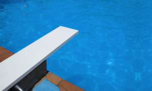 What You Need to Know About Swimming with an Ostomy - image of a diving board and pool